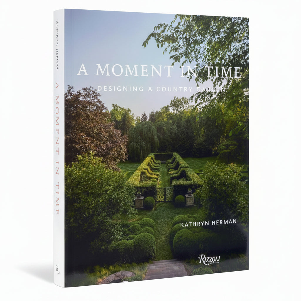 Book cover of 'A Moment in Time: Designing a Country Garden' by Kathryn Herman with a garden scene on the cover.