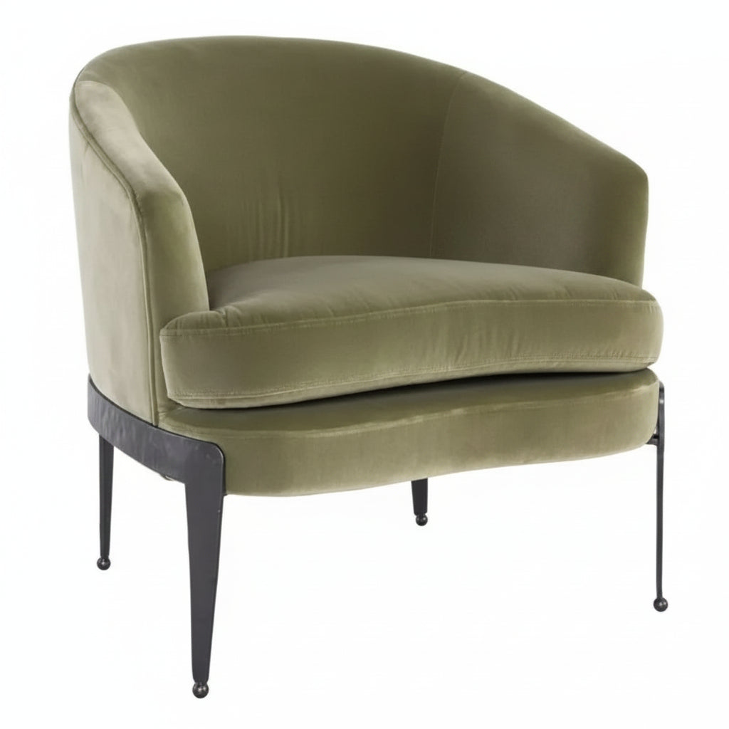 Green velvet armchair with black metal legs on a white background