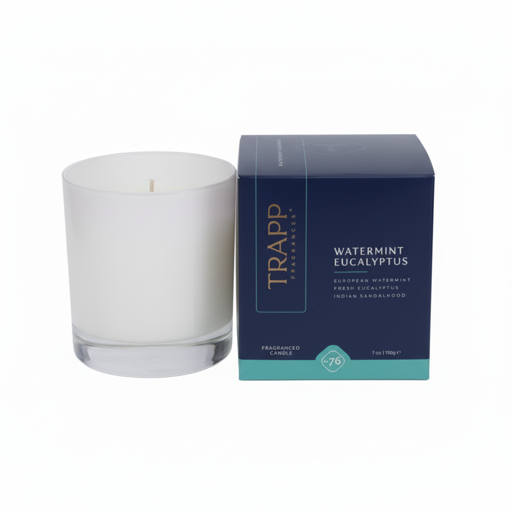 A lit Trapp candle with Watermint Eucalyptus scent, alongside its signature box, both featuring a clean and simple design in white and blue colors.