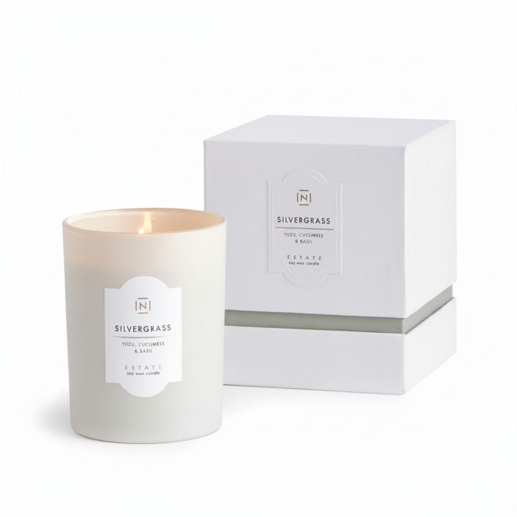 White candle with 'Silvergrass' label next to a matching white box on a white background