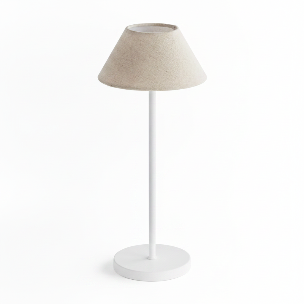 Table lamp with beige fabric shade and white base on a white background