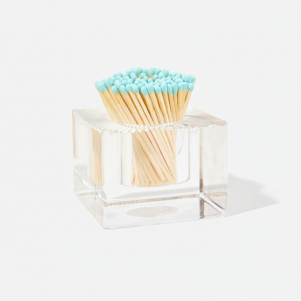 Clear matchbox with light blue matches on a white background
