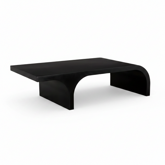 A modern black coffee table with a thick rectangular top and sculptural curved legs, shown against a plain white background.